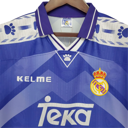 https://cdn.shopify.com/s/files/1/0826/7228/8075/files/19961997-real-madrid-teka-blue-away-retro-kit-classickits433-458576.webp?v=1741199048