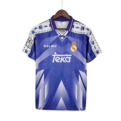 https://cdn.shopify.com/s/files/1/0826/7228/8075/files/19961997-real-madrid-teka-blue-away-retro-kit-classickits433-492912.webp?v=1741199046