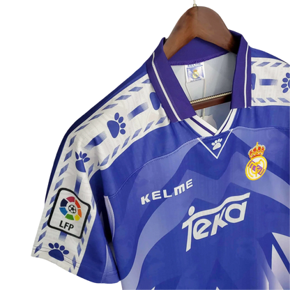 https://cdn.shopify.com/s/files/1/0826/7228/8075/files/19961997-real-madrid-teka-blue-away-retro-kit-classickits433-630882.webp?v=1741199048