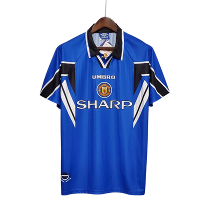 https://cdn.shopify.com/s/files/1/0826/7228/8075/files/19961998-manchester-united-sharp-blue-third-retro-kit-classickits433-549648.webp?v=1741199186