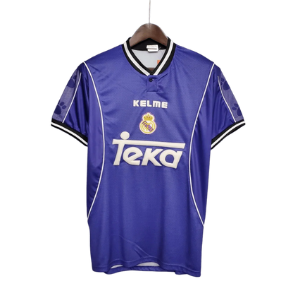 https://cdn.shopify.com/s/files/1/0826/7228/8075/files/19971998-real-madrid-teka-blue-away-retro-kit-classickits433-945680.webp?v=1741199033