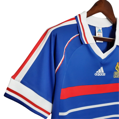 https://cdn.shopify.com/s/files/1/0826/7228/8075/files/1998-france-world-cup-home-retro-jersey-144160.webp?v=1741198760