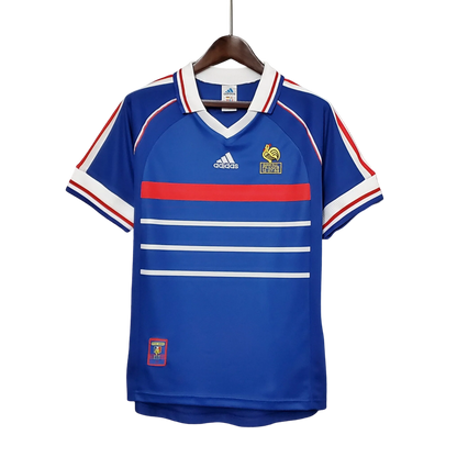 https://cdn.shopify.com/s/files/1/0826/7228/8075/files/1998-france-world-cup-home-retro-jersey-655251.webp?v=1741198760
