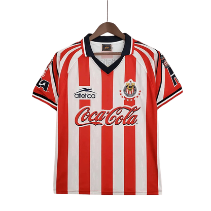https://cdn.shopify.com/s/files/1/0826/7228/8075/files/19981999-chivas-guadalajara-coca-cola-home-retro-jersey-312754.webp?v=1741197187