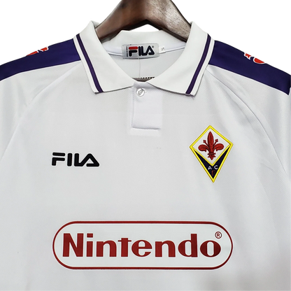 https://cdn.shopify.com/s/files/1/0826/7228/8075/files/19981999-fiorentina-florence-nintendo-fila-away-retro-kit-classickits433-142113.webp?v=1741199025