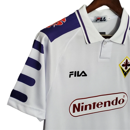 https://cdn.shopify.com/s/files/1/0826/7228/8075/files/19981999-fiorentina-florence-nintendo-fila-away-retro-kit-classickits433-798892.webp?v=1741199024