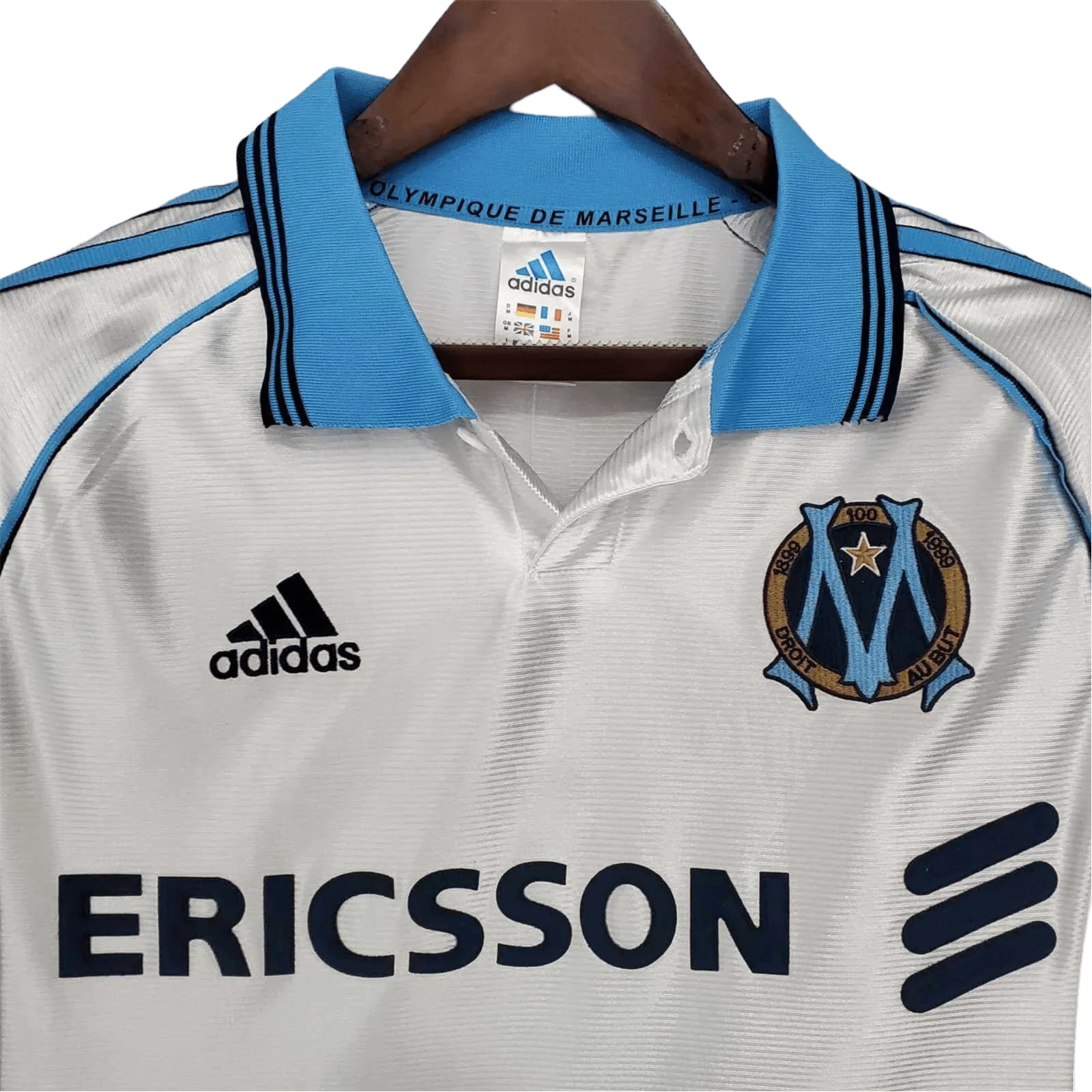 https://cdn.shopify.com/s/files/1/0826/7228/8075/files/19981999-olympique-de-marseille-ericsson-home-retro-jersey-210450.webp?v=1741199413