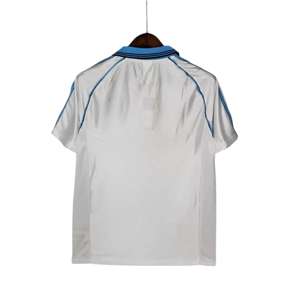 https://cdn.shopify.com/s/files/1/0826/7228/8075/files/19981999-olympique-de-marseille-ericsson-home-retro-jersey-729823.webp?v=1741199414