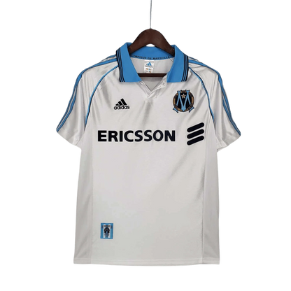 https://cdn.shopify.com/s/files/1/0826/7228/8075/files/19981999-olympique-de-marseille-ericsson-home-retro-jersey-802130.webp?v=1741199413