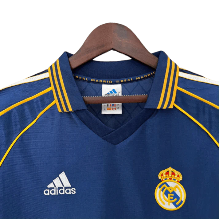 https://cdn.shopify.com/s/files/1/0826/7228/8075/files/19981999-real-madrid-teka-blue-third-retro-kit-classickits433-284420.webp?v=1741199020