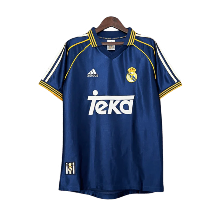 https://cdn.shopify.com/s/files/1/0826/7228/8075/files/19981999-real-madrid-teka-blue-third-retro-kit-classickits433-348625.webp?v=1741199018