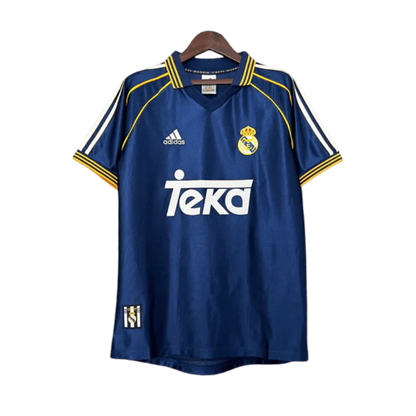 https://cdn.shopify.com/s/files/1/0826/7228/8075/files/19981999-real-madrid-teka-blue-third-retro-kit-classickits433-348625.webp?v=1741199018