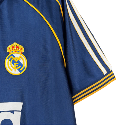 https://cdn.shopify.com/s/files/1/0826/7228/8075/files/19981999-real-madrid-teka-blue-third-retro-kit-classickits433-575040.webp?v=1741199020
