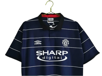 https://cdn.shopify.com/s/files/1/0826/7228/8075/files/19992000-manchester-united-sharp-digital-blue-away-retro-kit-classickits433-332856.webp?v=1741199146