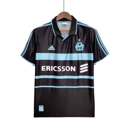 https://cdn.shopify.com/s/files/1/0826/7228/8075/files/19992000-olympique-de-marseille-ericsson-home-retro-kit-classickits433-900795.webp?v=1741199400