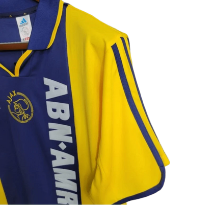 https://cdn.shopify.com/s/files/1/0826/7228/8075/files/20002001-ajax-abn-amro-away-retro-kit-classickits433-137131.webp?v=1741199336