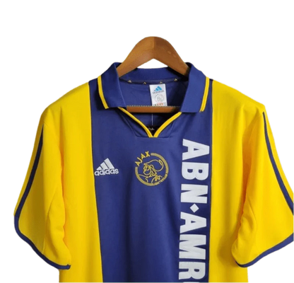 https://cdn.shopify.com/s/files/1/0826/7228/8075/files/20002001-ajax-abn-amro-away-retro-kit-classickits433-622387.webp?v=1741199339