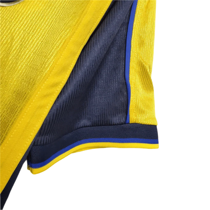https://cdn.shopify.com/s/files/1/0826/7228/8075/files/20002001-arsenal-sega-yellow-away-retro-kit-classickits433-104176.webp?v=1741199337