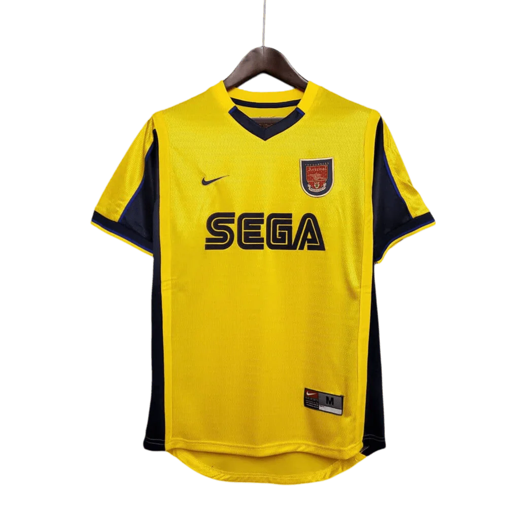 https://cdn.shopify.com/s/files/1/0826/7228/8075/files/20002001-arsenal-sega-yellow-away-retro-kit-classickits433-271552.webp?v=1741199340