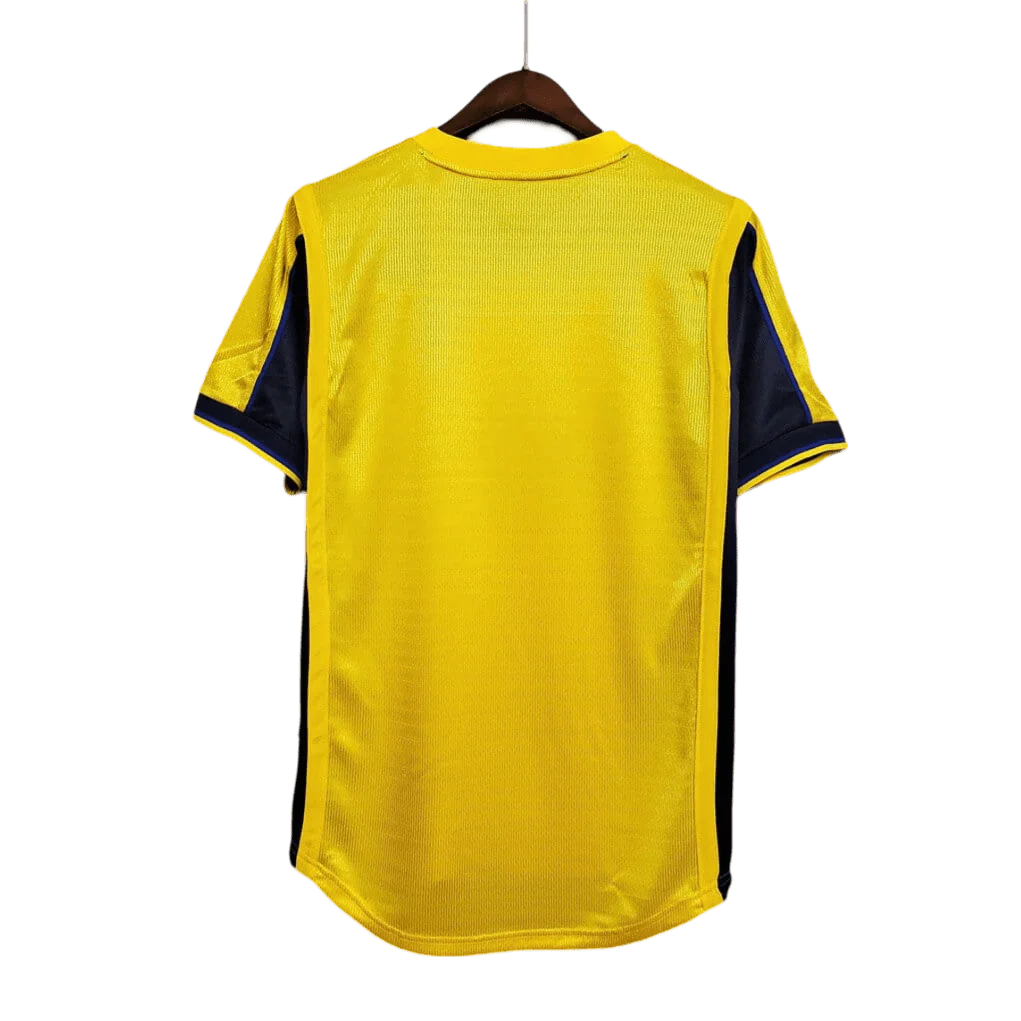 https://cdn.shopify.com/s/files/1/0826/7228/8075/files/20002001-arsenal-sega-yellow-away-retro-kit-classickits433-624195.webp?v=1741199342