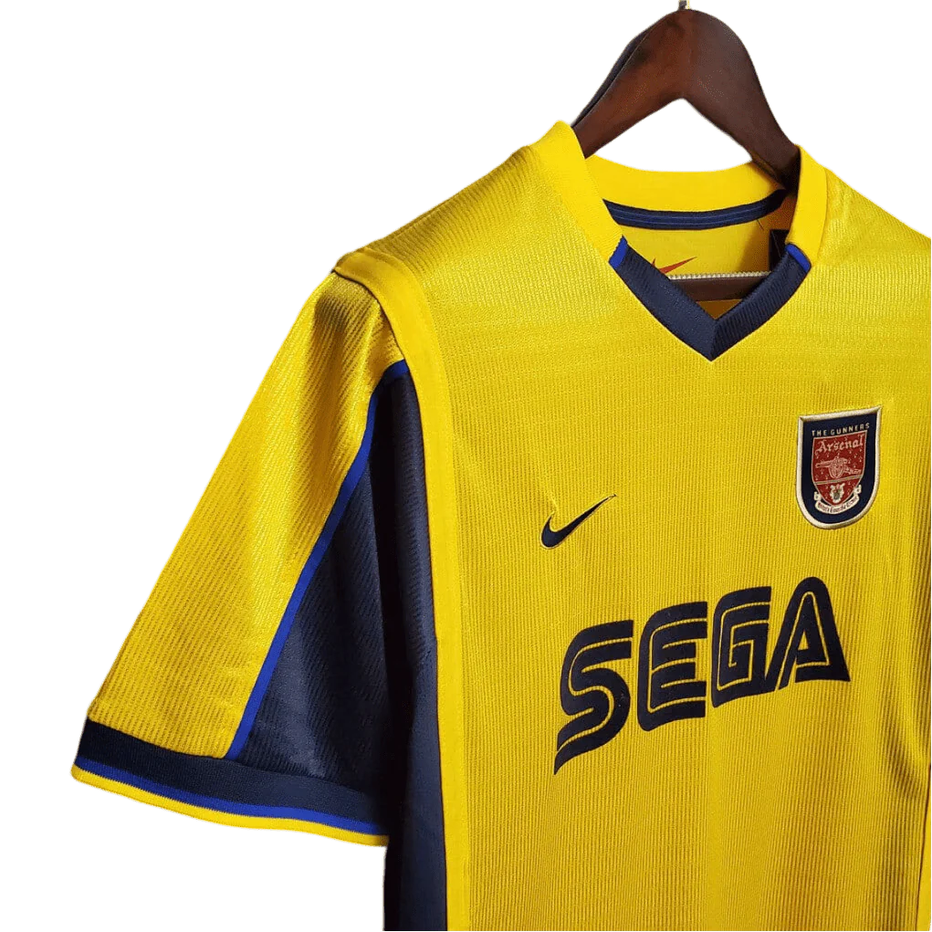 https://cdn.shopify.com/s/files/1/0826/7228/8075/files/20002001-arsenal-sega-yellow-away-retro-kit-classickits433-699228.webp?v=1741199339