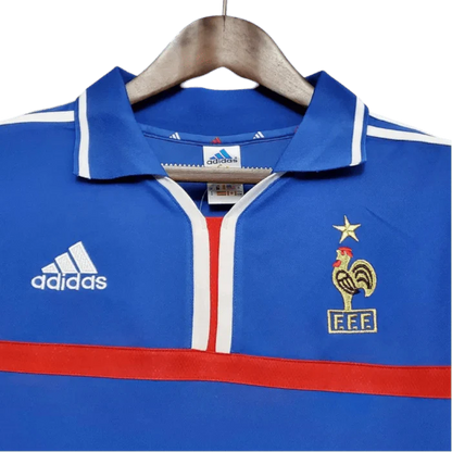 https://cdn.shopify.com/s/files/1/0826/7228/8075/files/20002001-france-home-retro-jersey-779401.webp?v=1741198520