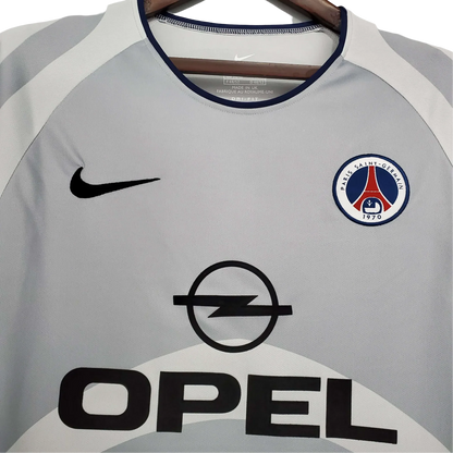 https://cdn.shopify.com/s/files/1/0826/7228/8075/files/20012002-paris-saint-germain-opel-away-grey-retro-jersey-297796.webp?v=1741198005