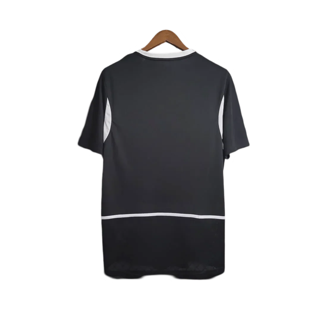 https://cdn.shopify.com/s/files/1/0826/7228/8075/files/2002-brazil-goalkeeper-dark-black-retro-kit-108256.webp?v=1741196943