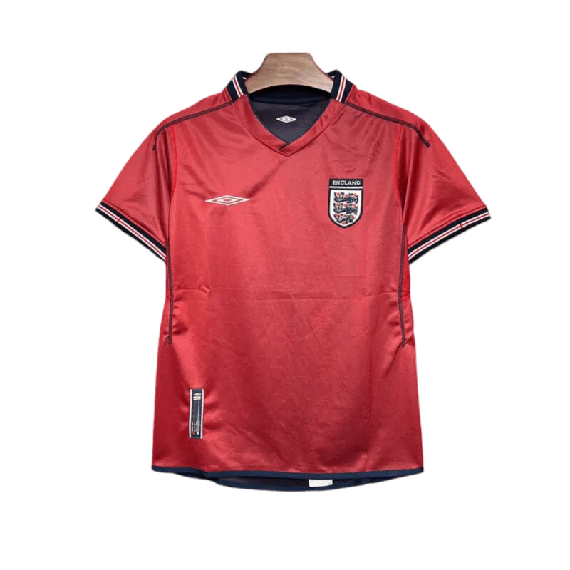 https://cdn.shopify.com/s/files/1/0826/7228/8075/files/2002-england-away-red-retro-kit-670279.webp?v=1741196952