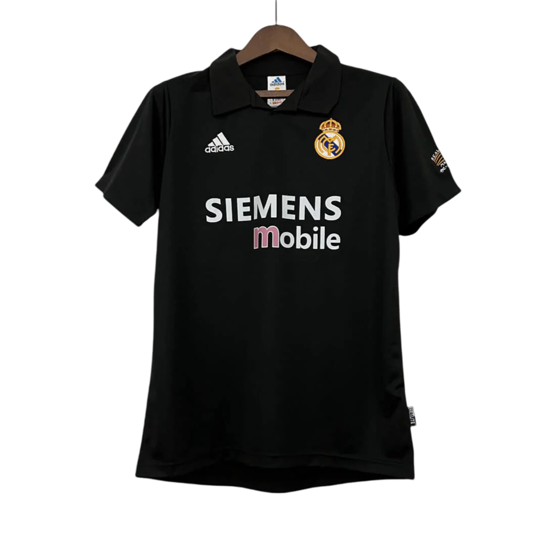 https://cdn.shopify.com/s/files/1/0826/7228/8075/files/20022003-real-madrid-siemens-mobile-black-retro-kit-classickits433-610917.webp?v=1741199016