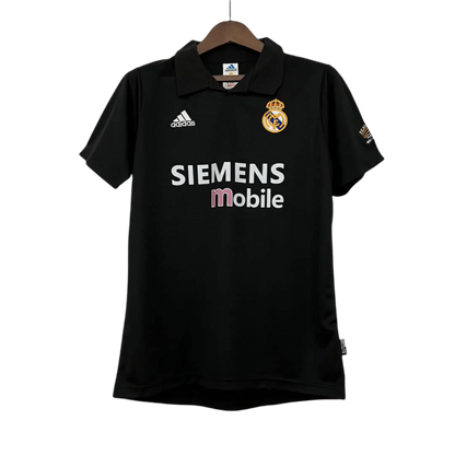 https://cdn.shopify.com/s/files/1/0826/7228/8075/files/20022003-real-madrid-siemens-mobile-black-retro-kit-classickits433-610917.webp?v=1741199016