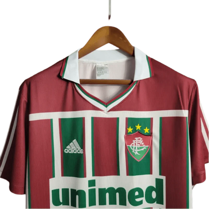 https://cdn.shopify.com/s/files/1/0826/7228/8075/files/2003-fluminense-unimed-home-retro-jersey-at-govintagejersey-697600.webp?v=1741197045