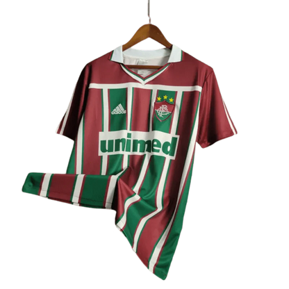 https://cdn.shopify.com/s/files/1/0826/7228/8075/files/2003-fluminense-unimed-home-retro-jersey-at-govintagejersey-927823.webp?v=1741197044