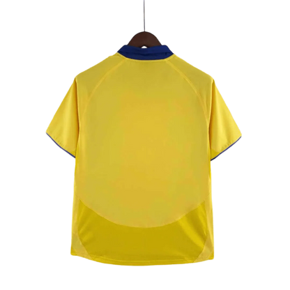 https://cdn.shopify.com/s/files/1/0826/7228/8075/files/20032005-arsenal-sponsor-o2-yellow-away-retro-kit-classickits433-779656.webp?v=1741199345