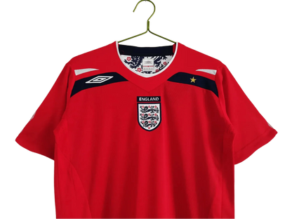 https://cdn.shopify.com/s/files/1/0826/7228/8075/files/2008-england-away-red-retro-kit-966767.webp?v=1741196952