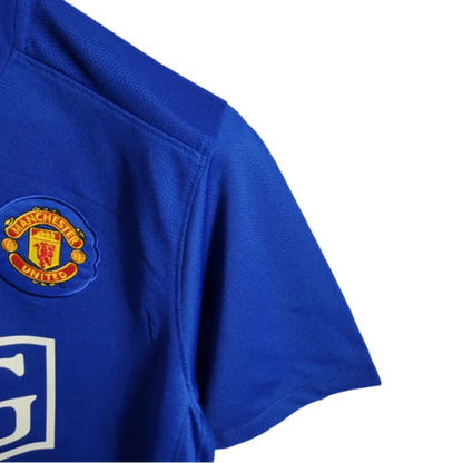 https://cdn.shopify.com/s/files/1/0826/7228/8075/files/20082009-manchester-united-aig-blue-third-retro-kit-classickits433-100477.webp?v=1741198442