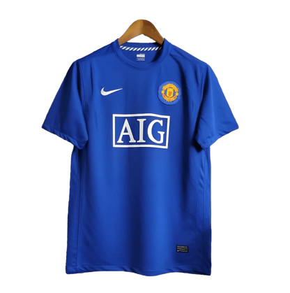 https://cdn.shopify.com/s/files/1/0826/7228/8075/files/20082009-manchester-united-aig-blue-third-retro-kit-classickits433-196423.webp?v=1741198443