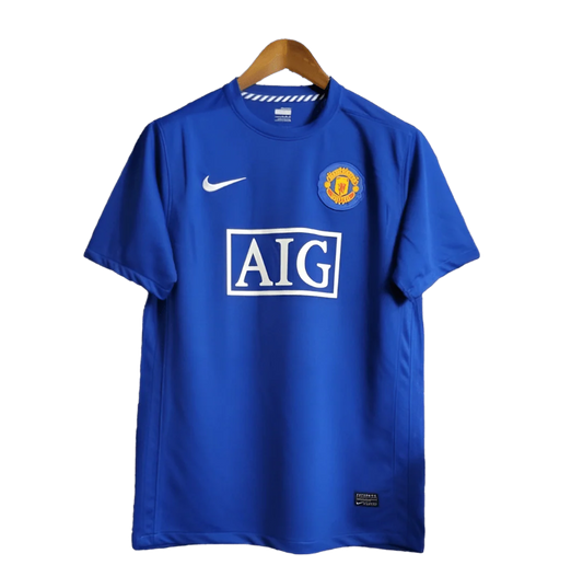 https://cdn.shopify.com/s/files/1/0826/7228/8075/files/20082009-manchester-united-aig-blue-third-retro-kit-classickits433-196423.webp?v=1741198443