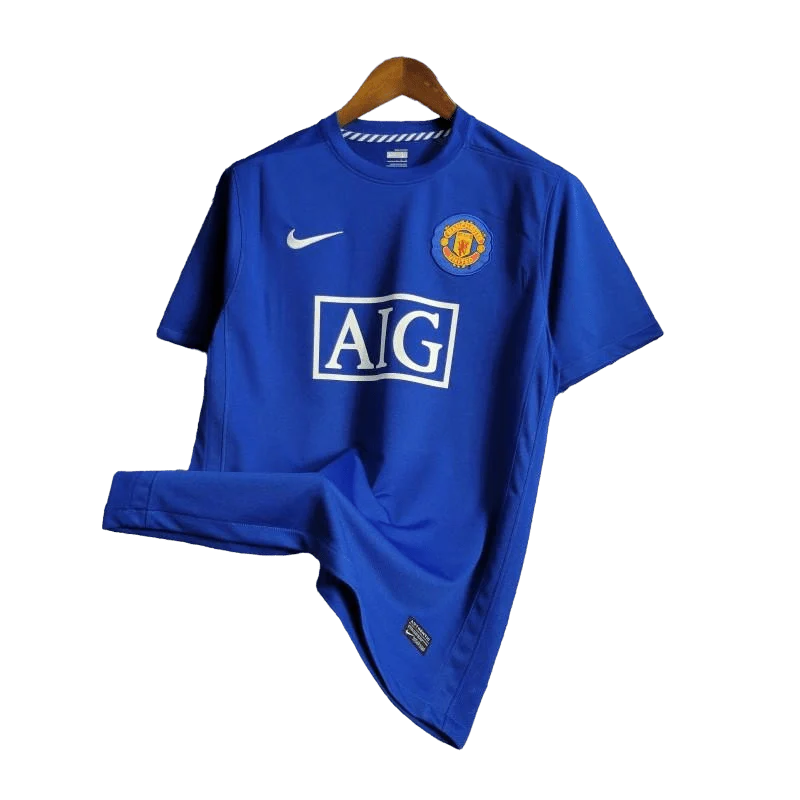 https://cdn.shopify.com/s/files/1/0826/7228/8075/files/20082009-manchester-united-aig-blue-third-retro-kit-classickits433-411169.webp?v=1741198443