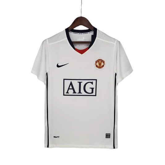 https://cdn.shopify.com/s/files/1/0826/7228/8075/files/20082009-manchester-united-aig-white-away-retro-kit-classickits433-439379.webp?v=1741198472
