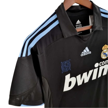 https://cdn.shopify.com/s/files/1/0826/7228/8075/files/20092010-real-madrid-bwin-away-retro-kit-374129.webp?v=1741197446
