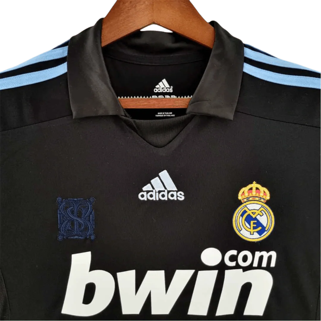 https://cdn.shopify.com/s/files/1/0826/7228/8075/files/20092010-real-madrid-bwin-away-retro-kit-570639.webp?v=1741197448