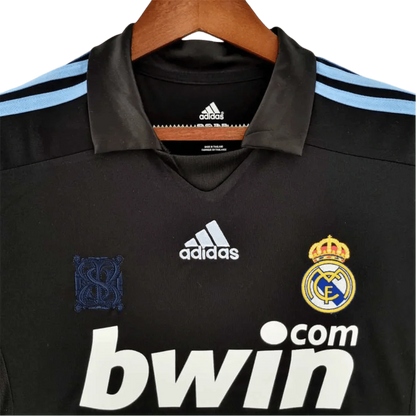https://cdn.shopify.com/s/files/1/0826/7228/8075/files/20092010-real-madrid-bwin-away-retro-kit-570639.webp?v=1741197448