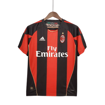 https://cdn.shopify.com/s/files/1/0826/7228/8075/files/20102011-ac-milan-fly-emirates-home-retro-kit-176147.webp?v=1741197283