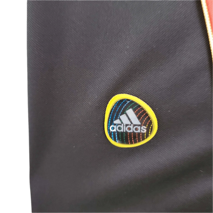 https://cdn.shopify.com/s/files/1/0826/7228/8075/files/20102011-ac-milan-fly-emirates-home-retro-kit-322760.webp?v=1741197285