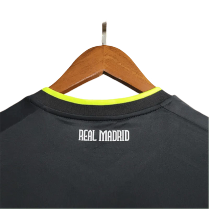https://cdn.shopify.com/s/files/1/0826/7228/8075/files/20102011-real-madrid-bwin-away-retro-kit-670256.webp?v=1741197268