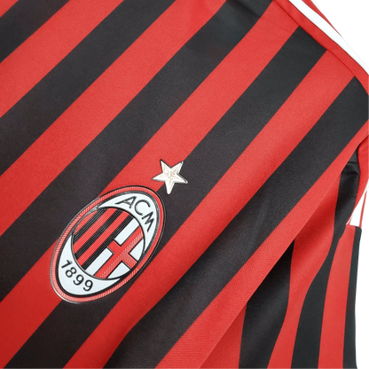https://cdn.shopify.com/s/files/1/0826/7228/8075/files/20112012-ac-milan-fly-emirates-home-retro-kit-859041.webp?v=1741197294
