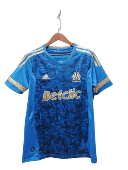 https://cdn.shopify.com/s/files/1/0826/7228/8075/files/20112012-olympique-de-marseille-betclic-blue-away-retro-jersey-735580.webp?v=1741197997