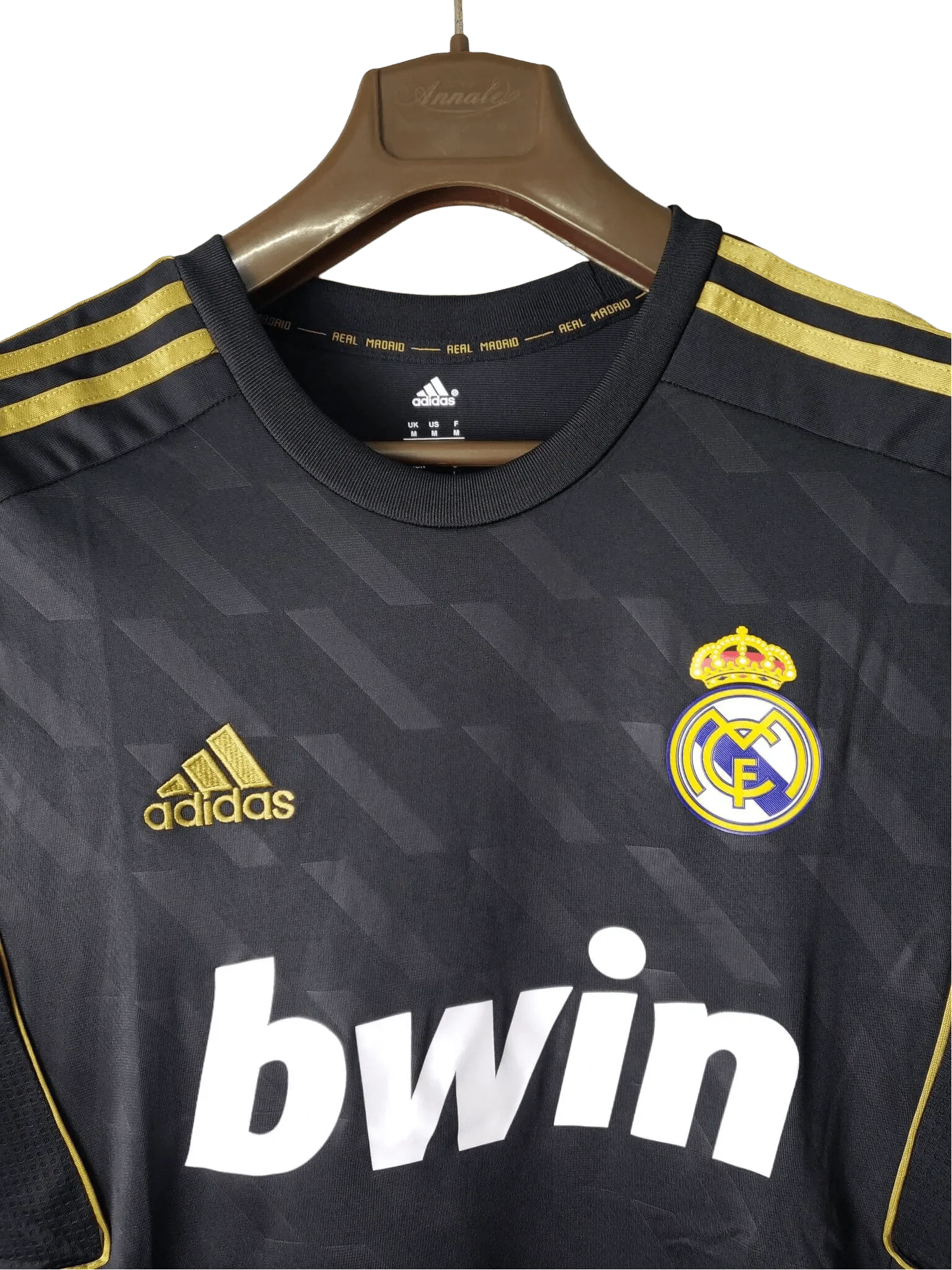https://cdn.shopify.com/s/files/1/0826/7228/8075/files/20112012-real-madrid-bwin-away-retro-kit-short-sleeve-416214.webp?v=1741197468