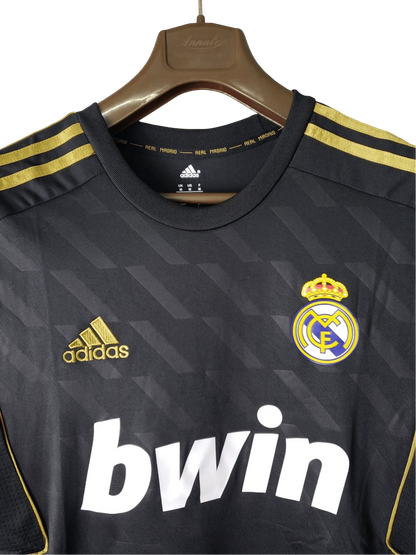 https://cdn.shopify.com/s/files/1/0826/7228/8075/files/20112012-real-madrid-bwin-away-retro-kit-short-sleeve-416214.webp?v=1741197468